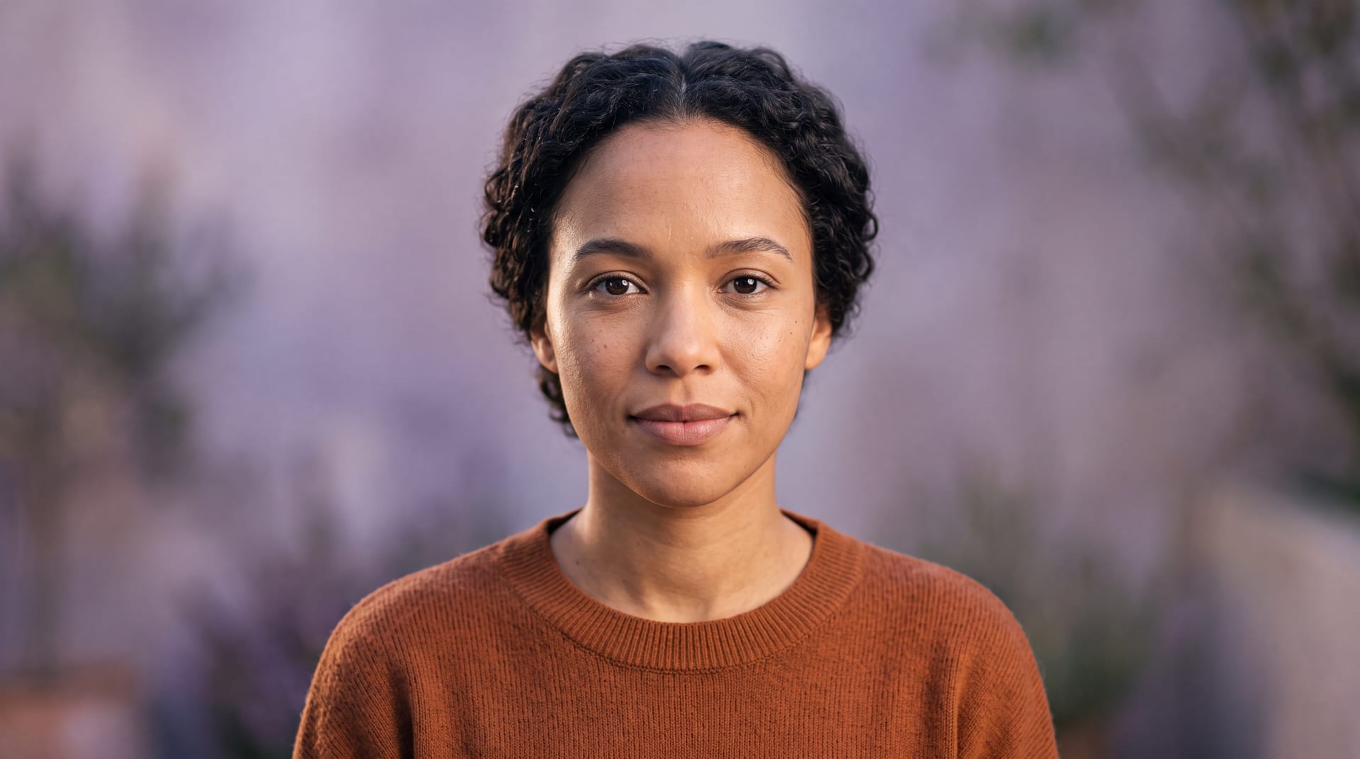 A South African adult looking calmly towards the camera